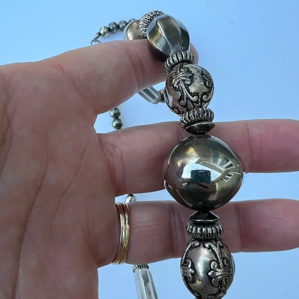 Tarnished silver color beaded necklace. Multiple shapes & sizes of silver color